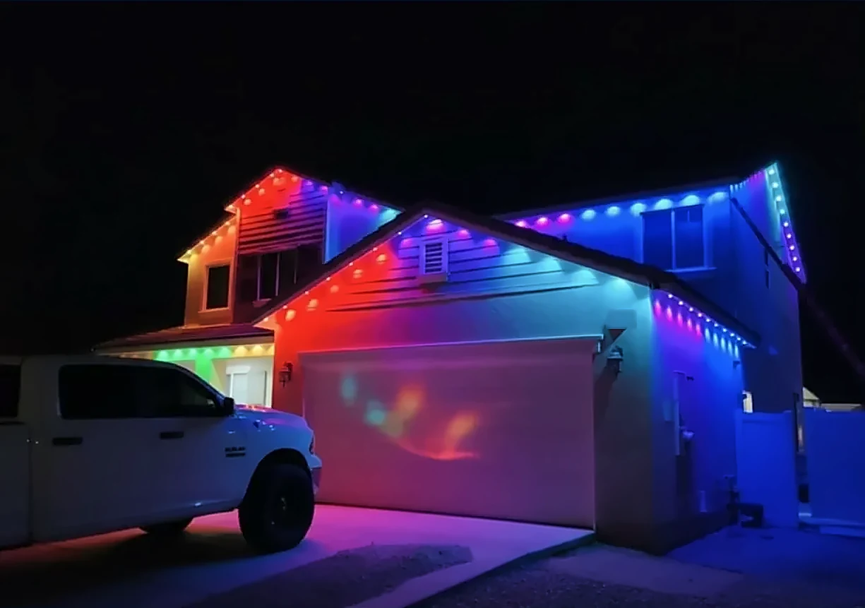 Two-story home with multicolor permanent roofline lights